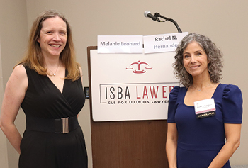 two women standing in front of a podium