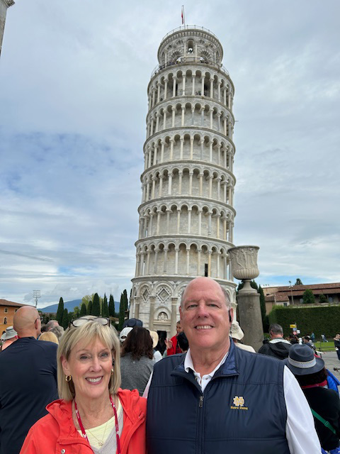 woman and man with Leaning Tower of Pisa in the background