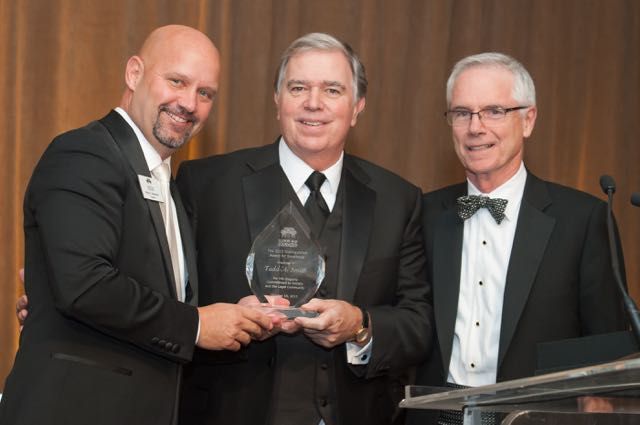 ISBA Past President Todd Smith (middle) is presented with the Illinois Bar Foundation's Distinguished Award of Excellence from IBF President Shawn Kasserman (left) and Gala Co-Chair Kevin Conway. 